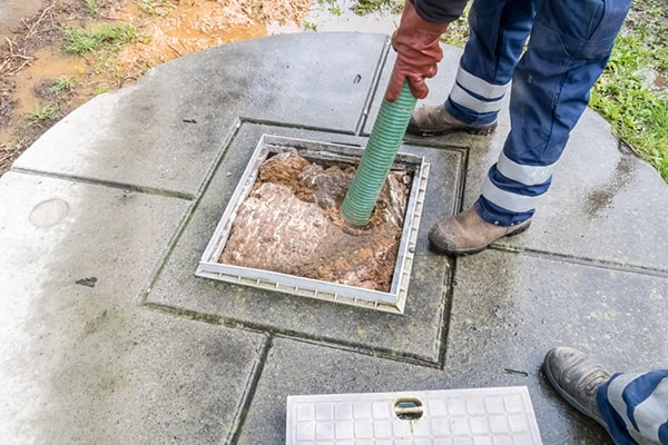 cesspool pumping is typically conducted using a large vacuum truck with a suction hose